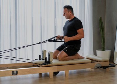 Side profile of folding Pilates reformer for home use